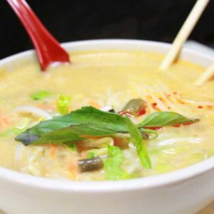 Koapoon soup, pictured with noodles in a savory coconut curry broth.